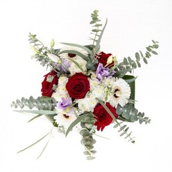 With the practiced touch of a Harold Hill floral artisan, this bouquet stands as a testament to quiet confidence and refined balance. Embodying both classic and contemporary elements, it's anchored by lush red roses whose spirals hint at stories of affection and intimacy, thoughtfully arranged to draw in the eye. Radiant white gerbera daisies circle around, their coffee-toned centres and delicate petals framing the bouquet like rays of sunlight stretching across a familiar garden bench near Gooshays Drive. Airy sprigs of soft lavender lisianthus push through the arrangement, introducing modern softness and an echo of early morning fog along Harold Hill's neighbourhood lanes. Wisps of fine, fluffy white filler blossoms mesh seamlessly, adding motion and a sense of gentle abundance. Eucalyptus leaves in frosted green glide above, introducing both texture and a soothing aroma aligned with Harold Hill's peaceful open spaces. The broad, dark leaves at the base wrap like a comforting embrace, all contained within a pristine glass vase where fresh stems can be clearly admired. This bouquet's sensory layers-rich blooms, fragrant greens, plush texture-come together for moments both celebratory and compassionate, faithfully representing the care and dedication of Harold Hill's floral community.