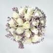 This bouquet, inspired by Harold Hill's tranquil landscapes, radiates effortless charm, as if plucked from the soft embrace of a peaceful morning. At its center, immaculate white roses unfurl in plush, velvety spirals, each petal hinting at fresh starts and gentle intentions. Threaded among them are dainty clusters of pale lavender statice, their lace-like forms adding delicate texture and airy lightness, reminiscent of wildflowers in the meadows beyond Settle Road. Against a softly illuminated backdrop, every bloom appears uniquely vivid, reinforced by gentle hints of green that bring the countryside's freshness into the home. This arrangement exudes quiet calm and subtle sophistication, designed for moments of heartfelt comfort, celebration, or thoughtful congratulation. Each detail, from the cooling, natural light to the lingering fragrance of fresh roses, is a tribute to the skill and care of local Harold Hill florists and the community's enduring warmth.
